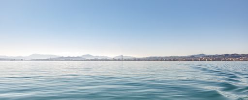 A beautiful panoramic shot of the buildings and mountains in Malaga visible from the Mediterranean sea