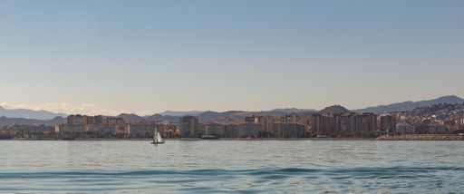 A beautiful panoramic shot of the buildings and mountains in Malaga visible from the Mediterranean sea