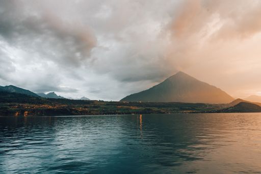 A high hill near the Thun lake under the cloudy sky in the evening in Merligen, Switzerland