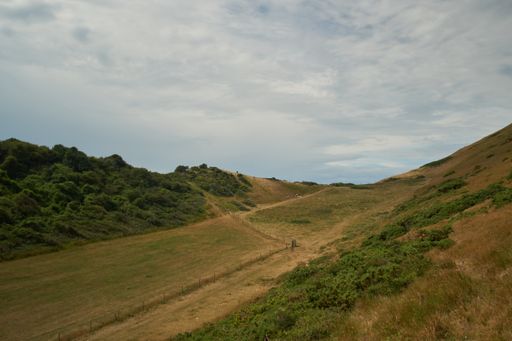 A high angle shot of a field between hills