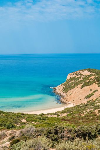 A vertical aerial view of a beautiful seashore with a rocky cliff in Kef Abbed, Tunisia