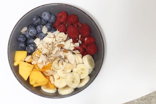 A top view of a delicious breakfast bowl with berries and coconut