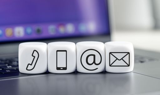 Contact us icons on white cube blocks on laptop. Business communication