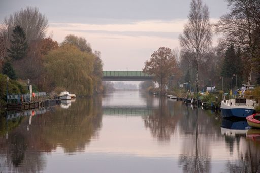 A beautiful shot of a lake with boat docks on each side and a bridge across it