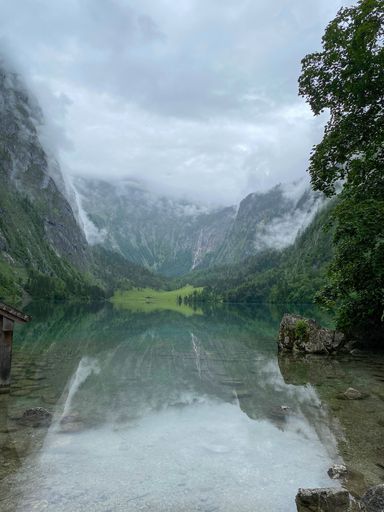 Lake with mountain panorama and fog in the background
