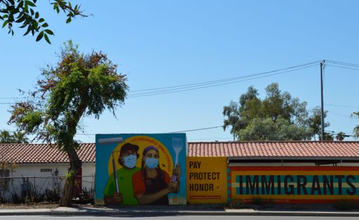A man and woman Mexican Immigrants with Paintbrush, Spatula, Pro-Immigration Mural