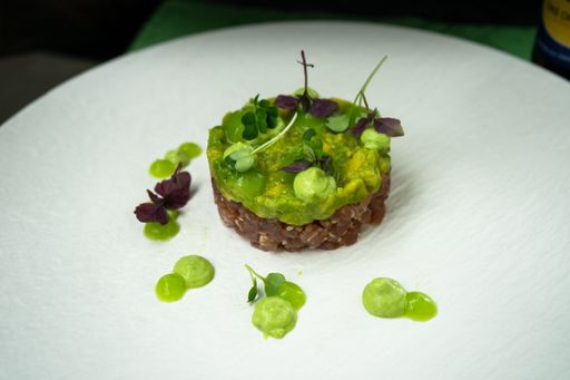 A high angle shot of a tasty looking green dessert in a white plate