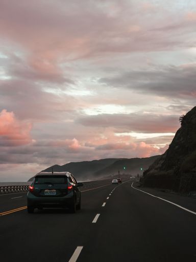A vertical shot of a scenic pink cloudy sunset on the coastline of Taitung, Taiwan