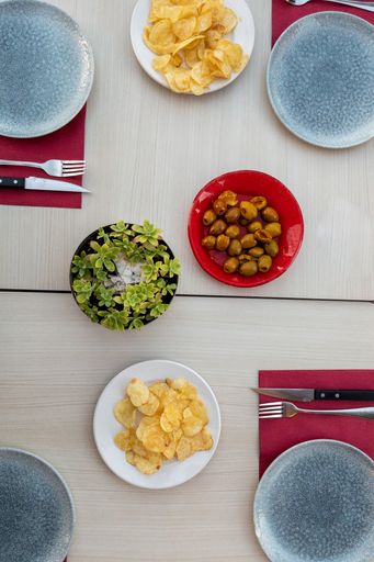 A top view of Spanish tapas with dishes on a wooden table
