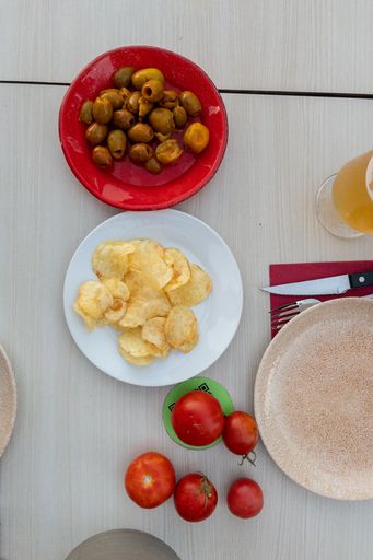 A top view of Spanish tapas with dishes on a wooden table