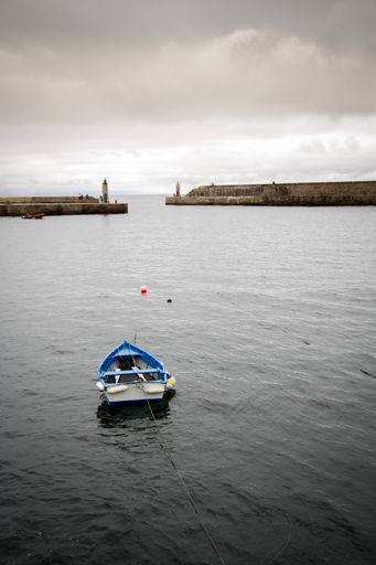 A vertical shot of a bay with an old boat on the foreground - perfect for background