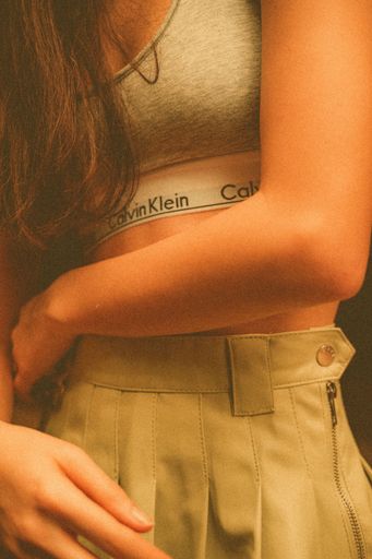 A vertical shot of a young girl wearing a Calvin Klein bra