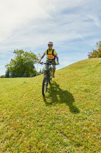 A biker in the mountains of Zurich under the bright sunlight