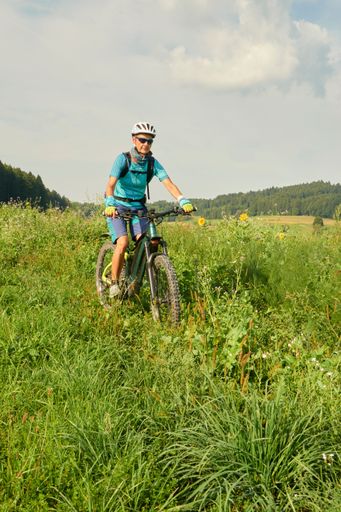 A biker in the mountains of Zurich under the bright sunlight