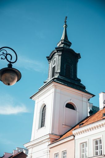 A vertical shot of a church tower in Warsaw on a sunny day, Poland