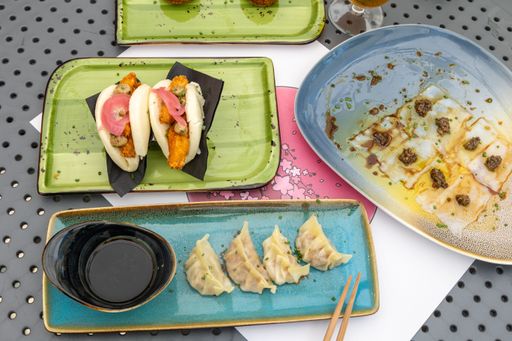 A high-angle shot of different types of traditional Asian dishes served at a local Asian restaurant