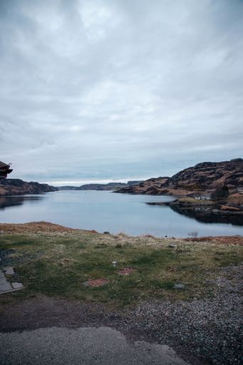 a vertical Beautiful shot of water near misty scottish highlands