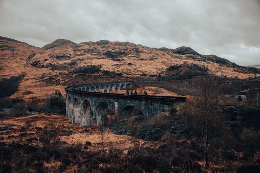 a high angle shot of famous Glenfinnan Viaduct bridge from Harry Potter during fall, scottland