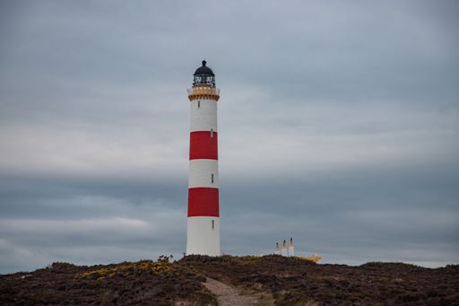 A a path leading up to the Tarbatt Ness Lighthouse in Scotland on a cloudy day