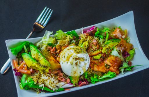 A healthy salad with rice avocado and chopped vegetables