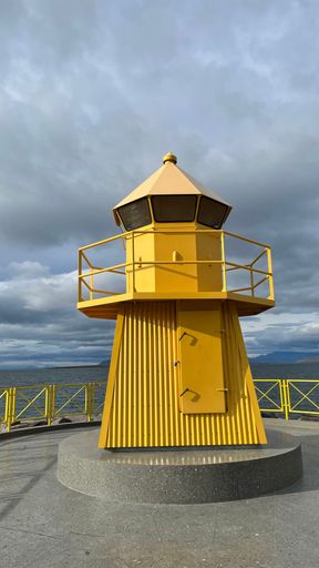 A beautiful view of a yellow lighthouse, Tourist attraction in Reykjavik, Iceland