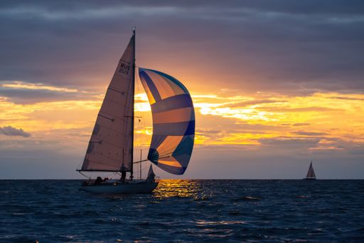 A sailboat on the water at sunset