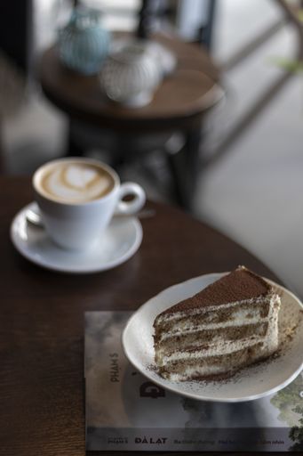 A vertical shot of a tiramisu cake on the table