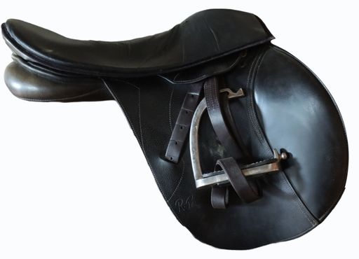 A black leather horse saddle isolated on a white background