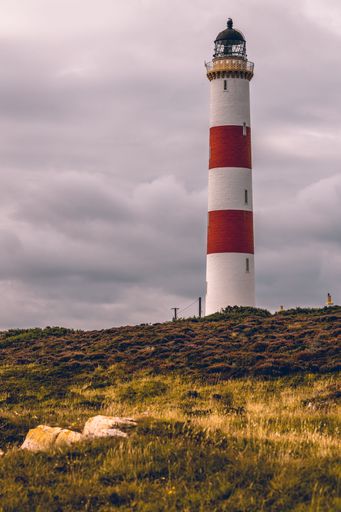 The Tarbat Ness Lighthouse in Scotland against a cloudy sky