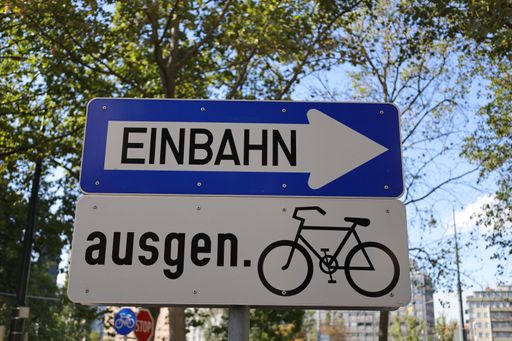 A traffic sign in Austria indicating a one way street with an arrow pointing right above a bike sign