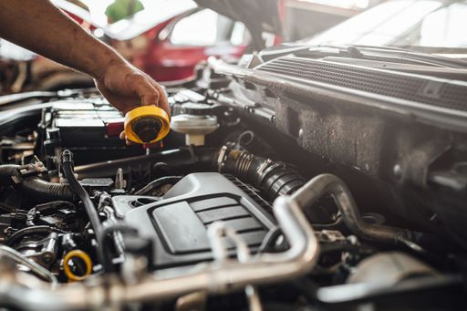 An auto mechanic working on a car engine, technical car inspection in service