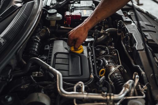 An auto mechanic working on a car engine, technical car inspection in service