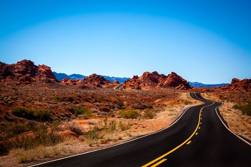 A scenic view of a highway road among a rocky desert