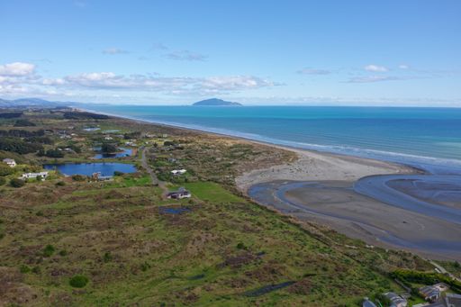 aerial shot of Waikawa beach looking south to Wellington and Kapiti Island on a fine blue sky day. the river mouth is in the foreground