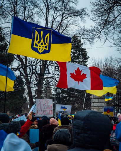 A vertical shot of flags and banners during Ukraine support rally in London, Ontario, Canada