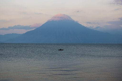 The beautiful view of the smooth water with a mountain in the background. Lake Atitlan, Guatemala.