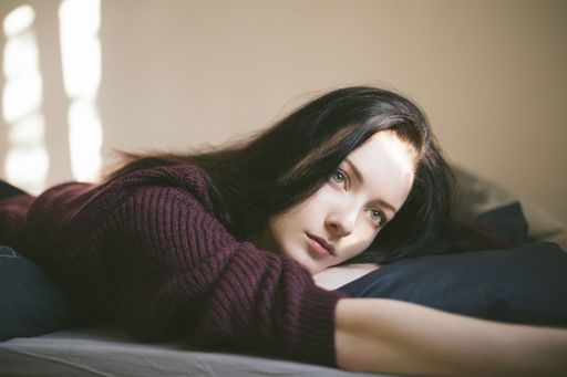 Young Beautiful Woman Daydreaming And Thinking While Looking Out Of The Window