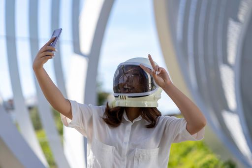 woman dressed as an astronaut taking a photo
