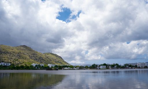Mallorca, Spain - JULY 17, 2020. Nice clouds reflecting in a lake with mountains in the background.