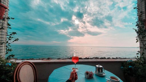 Spritz Aperol beautiful sea view with plants bar by the sea at sunset
