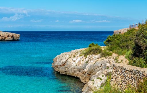A scenic view of the Mallorca shoreline with crystal blue water, Spain.