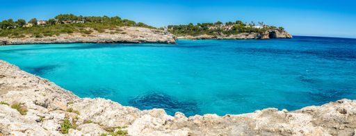 Playa de Cala Mandia beach on a sunny day