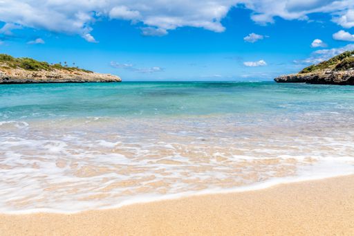 Playa de Cala Mandia beach on a sunny day