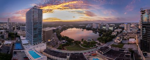 An aerial view of a sunrise over lake Eola in Orlando