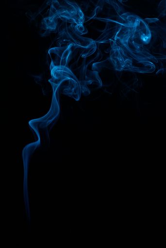 A vertical shot of blue tobacco smoke on a black background
