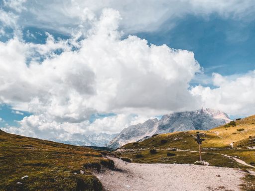 A dry hillside in the highlands on a bright sunny day with fluffy clouds in the sky