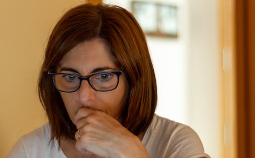 A shallow focus shot of a middle-aged female looking on the screen