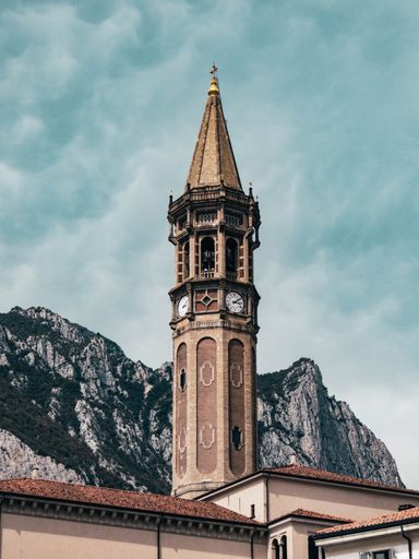 The ancient tower of San Nicolo against the mountain and clouds