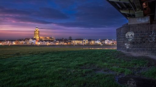a beautiful view of deventer city from under deveneter bridge during bluehour