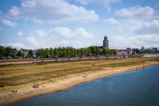 A beautiful view of a beach and city in the background in Deventer, Netherlands